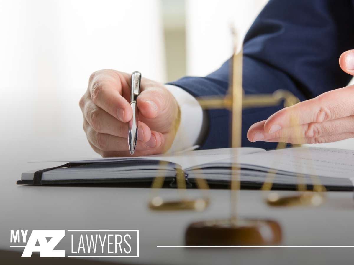 A lawyer from My AZ Lawyers prepares to address legal issues related to leaving a firearm accessible to a child, depicted by a close-up of a hand signing documents with a gavel in the background.