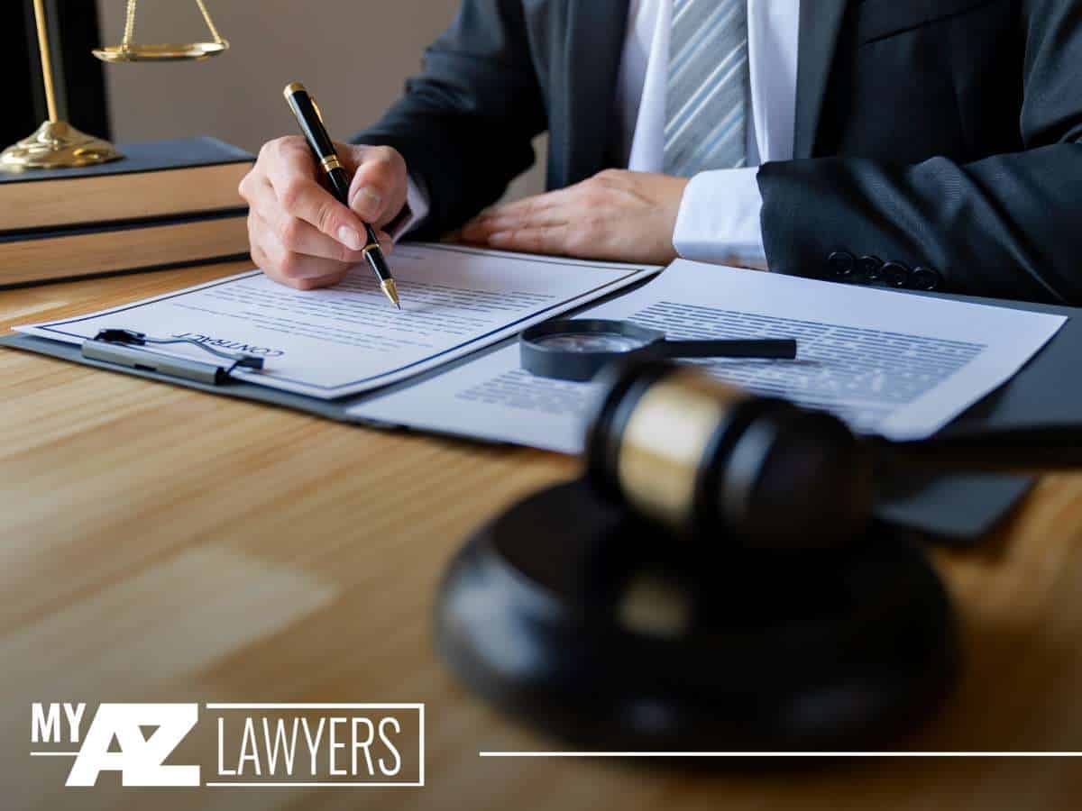 Lawyer reviewing mortgage documents with scales and gavel on desk