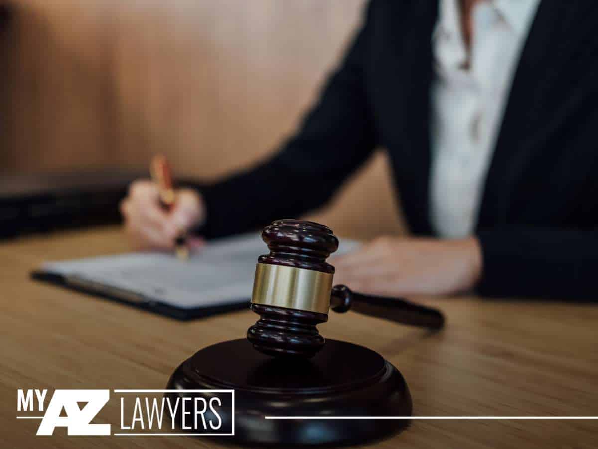 Lawyer signing documents with gavel on desk, representing Bankruptcy proceedings