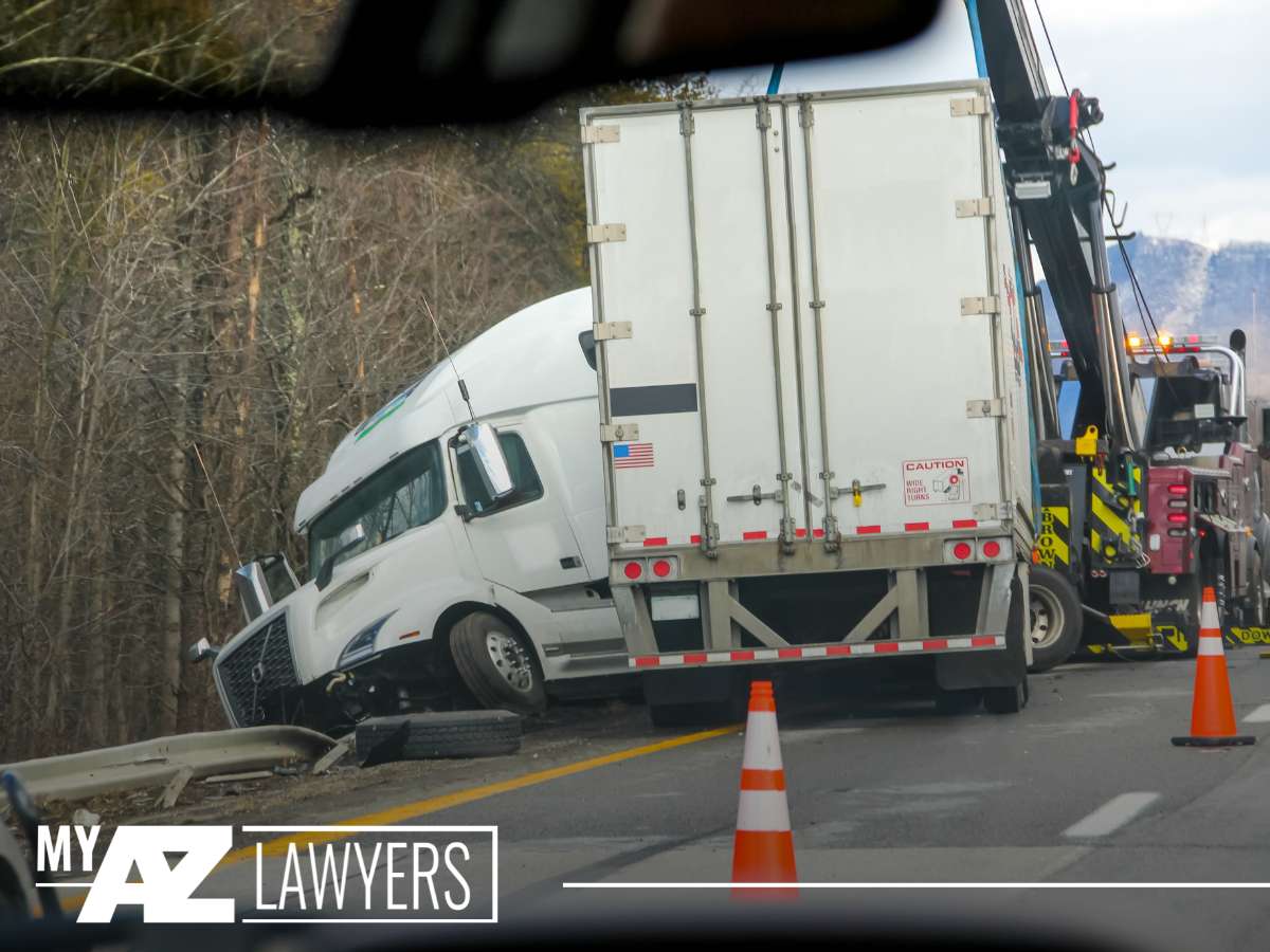 Overturned truck being towed after a Semi-Truck Accident on a highway