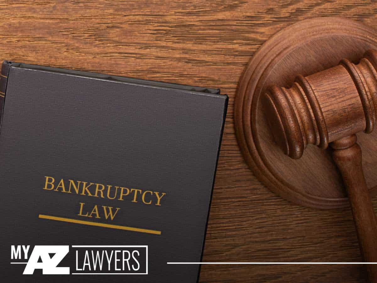Bankruptcy law book and gavel on wooden desk